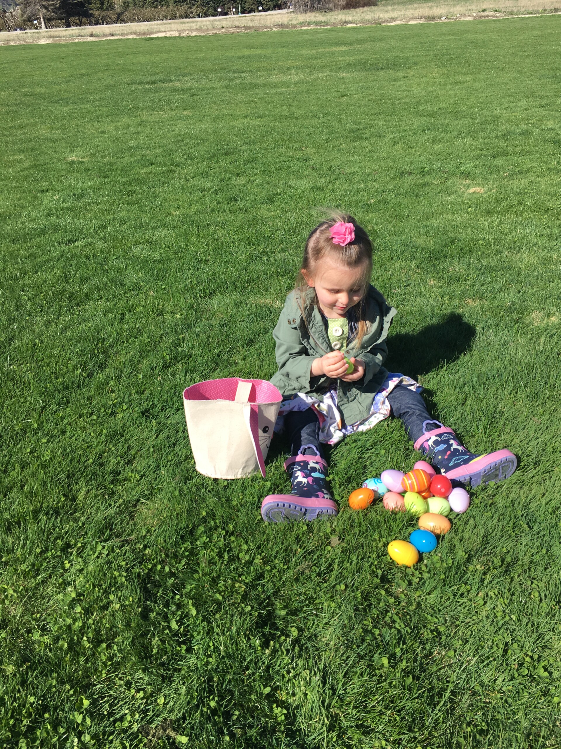 girl child easter egg hunt park grass spring